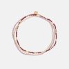 Handgemachter Schmuck aus Nepal mit Perlen in Gold, Rosa und Dunkelrot. Kleiner Anhänger