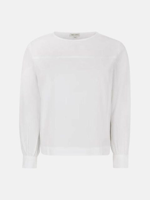 Klassische weisse Bluse von vorne ersichtlich. Die Ärmel sind locker und haben Verengungen bei der Manschette mit Knöpfen